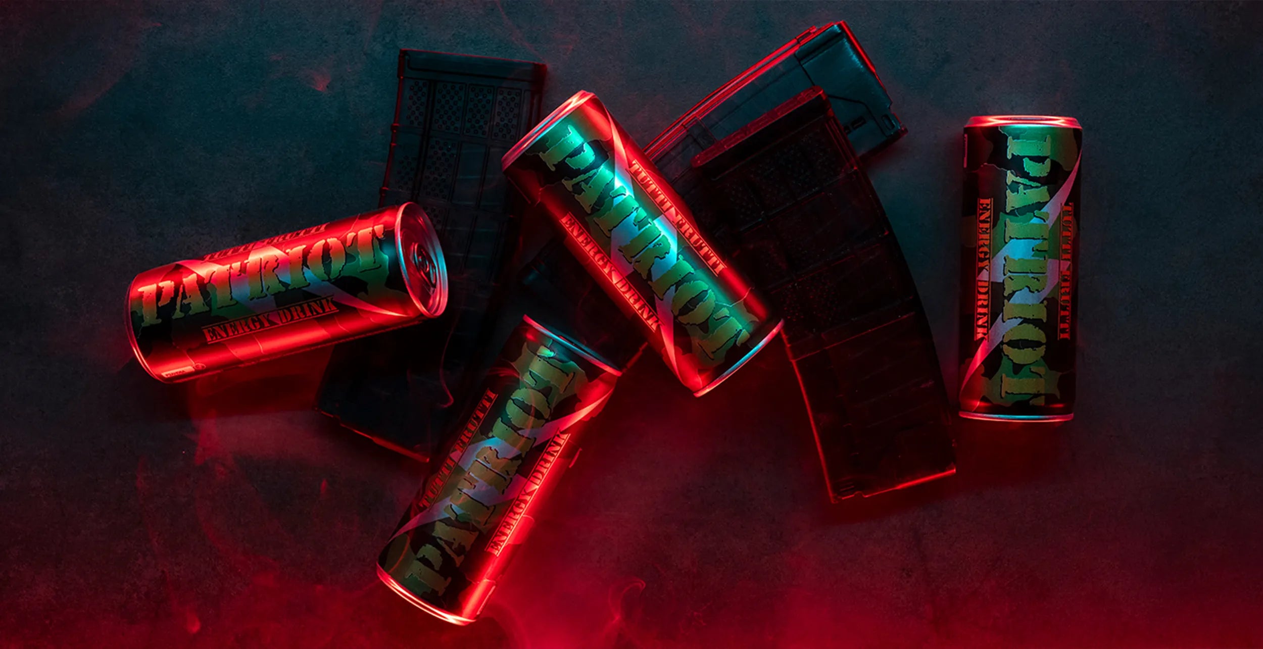 image of 4 cans of Patriot classic energy drinks laying across ammunition magazines